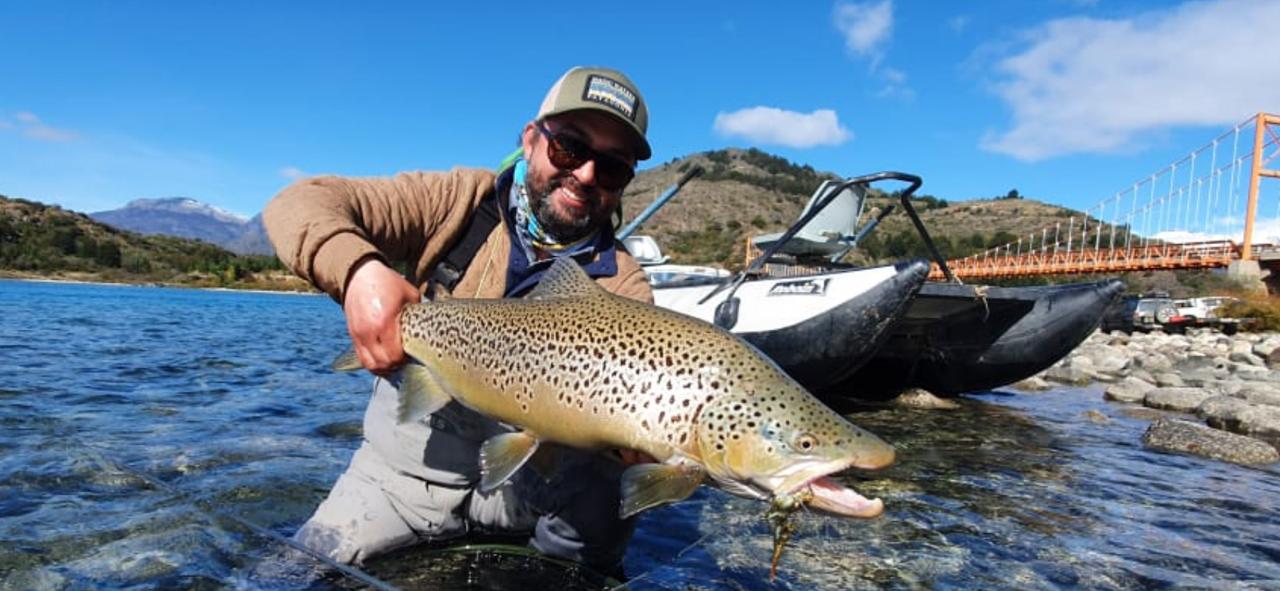 Eduardo Barrueto holding a trophy brown trout at Magic Waters near Coyhaique, Patagonia